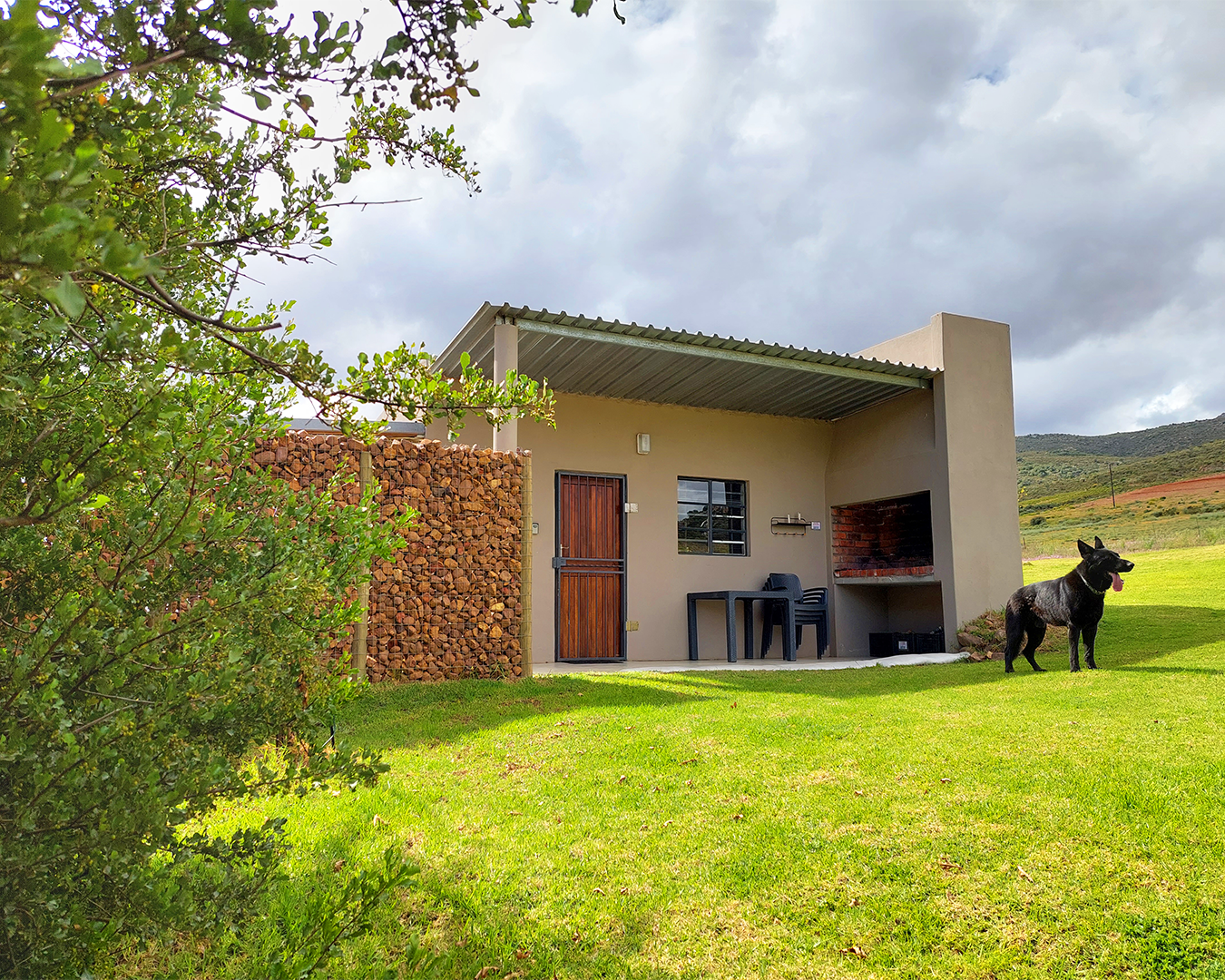 Farm cottage exterior view with mountain backdrop