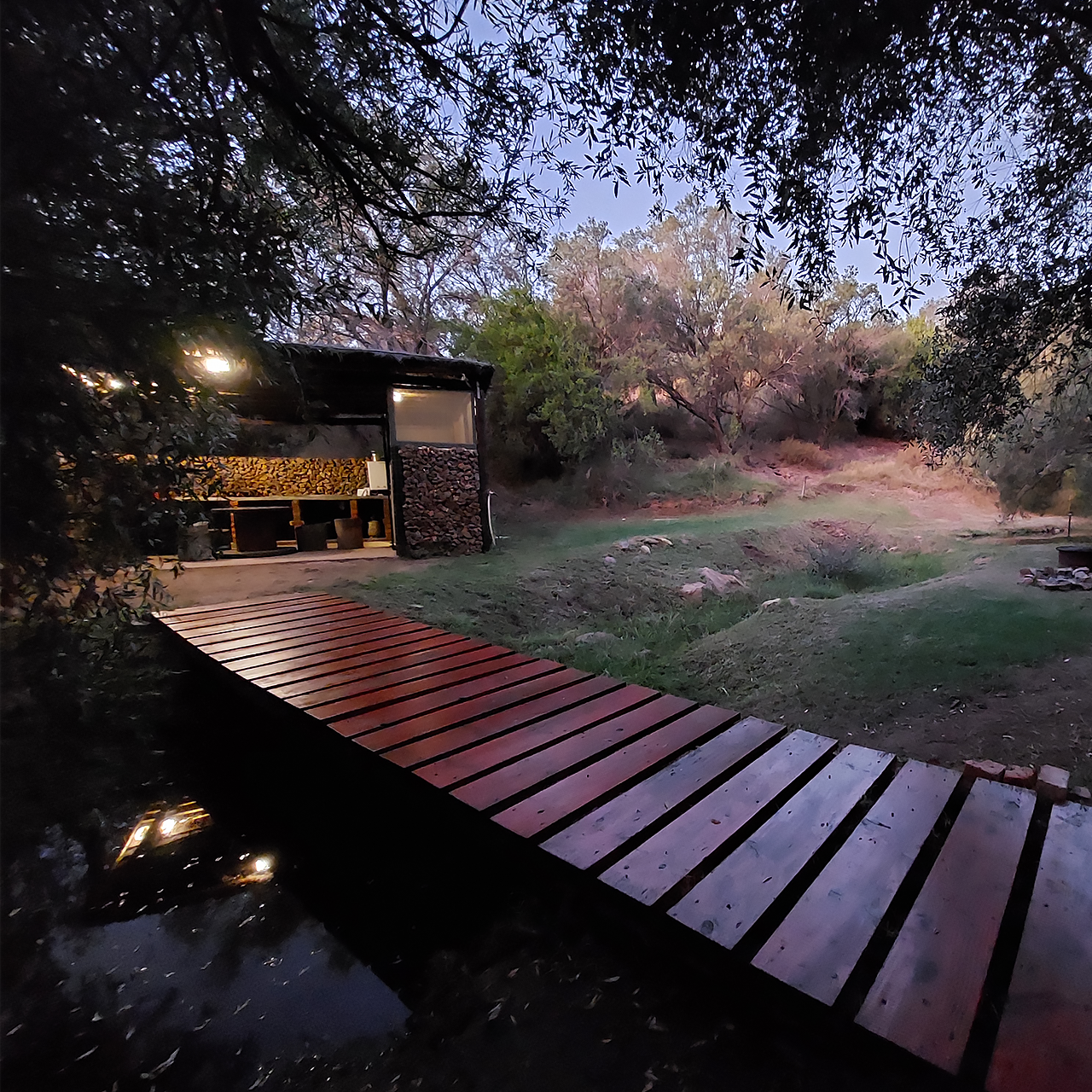 Forest campsite facilities at evening with wooden decking